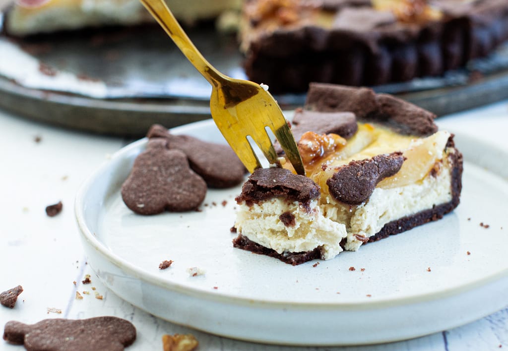 Herbstgenuss: Birnentarte mit Skyr Creme und karamellisierten Walnüsse Stück am Teller mit Gabel